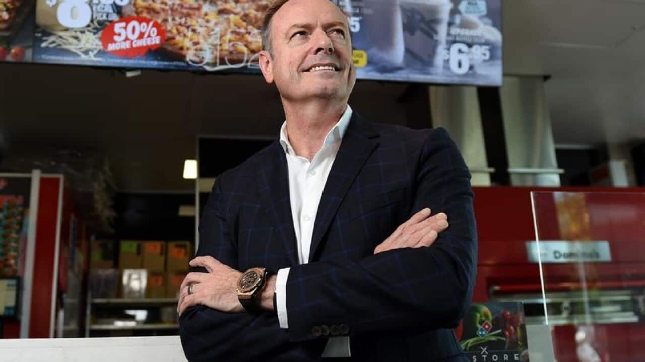 Don Meij poses for a photo at a Domino's store.