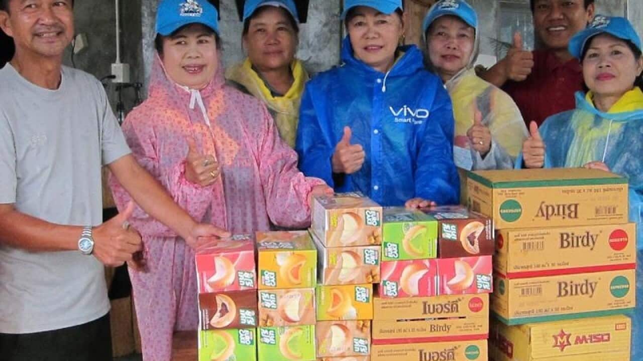 Village volunteers pose for a photograph with supplies