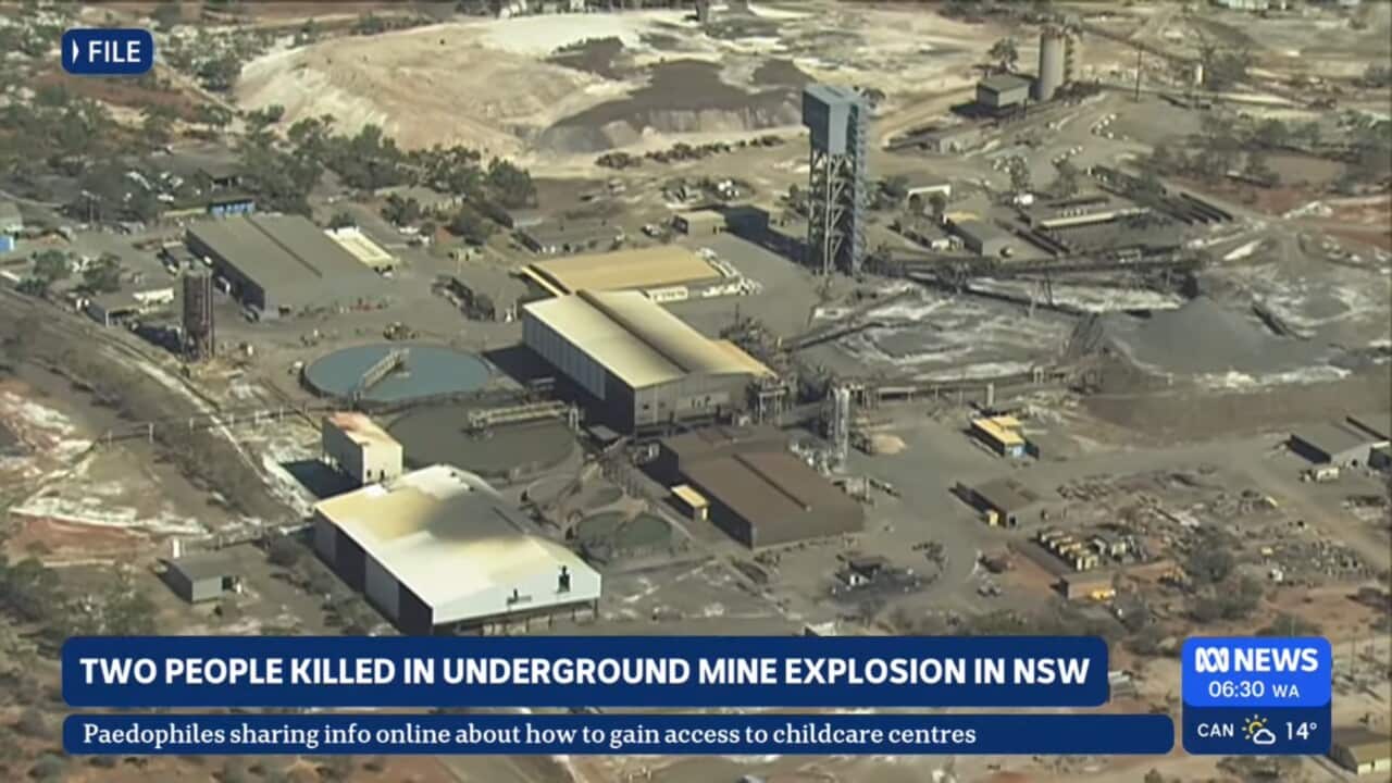 A screengrab from an ABC news program showing an aerial shot of a mining site, showing industrial buildings and mining equipment.