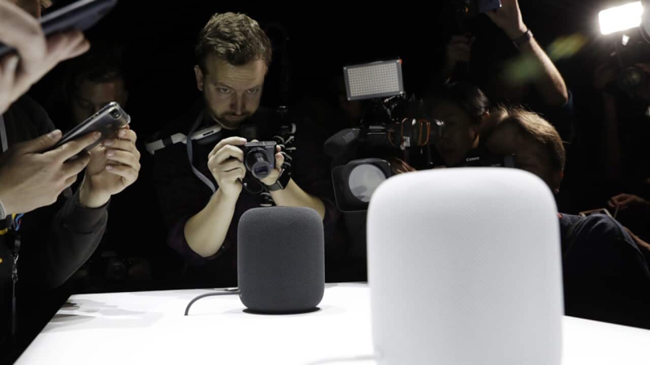 The HomePod speaker is photographed in a showroom