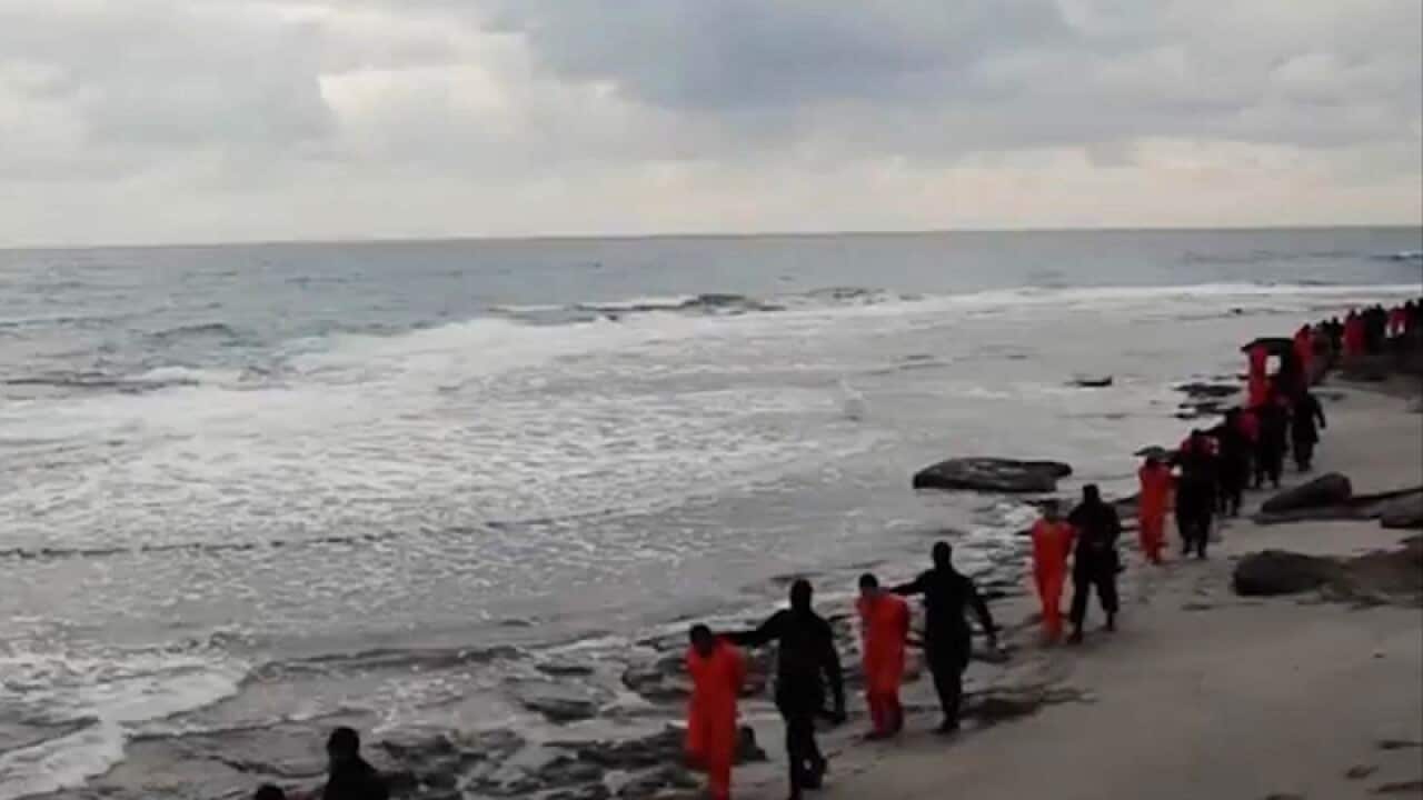Islamic State members leading Egyptian Coptic Christians along a beach