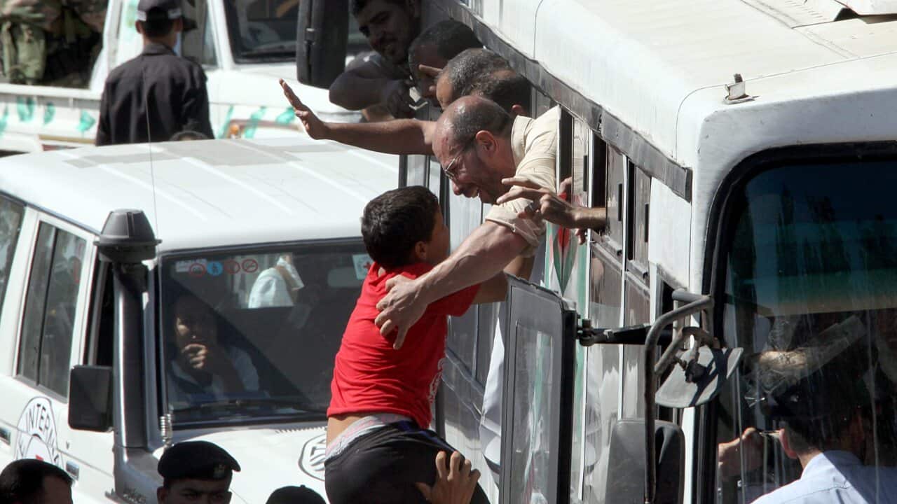 Freed Palestinian prisoners arrive in a bus as they are welcomed by large crowds at the Rafah border crossing between the Gaza strip