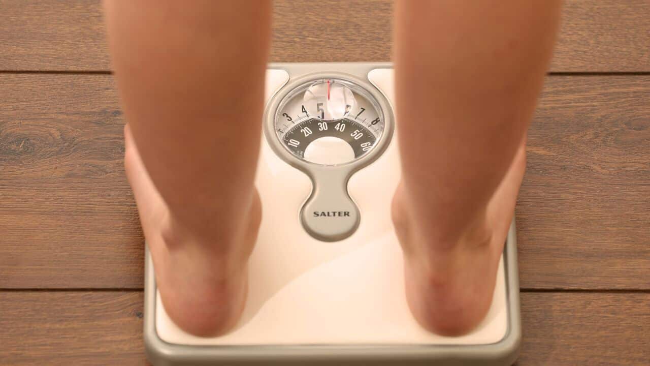 File photo dated 03/03/14 of a woman using a set of weighing scales as more must be done to help people who have lost weight to keep the pounds off, experts have said.. Issue date: Wednesday May 14, 2014. Interventions that help people keep the weight off