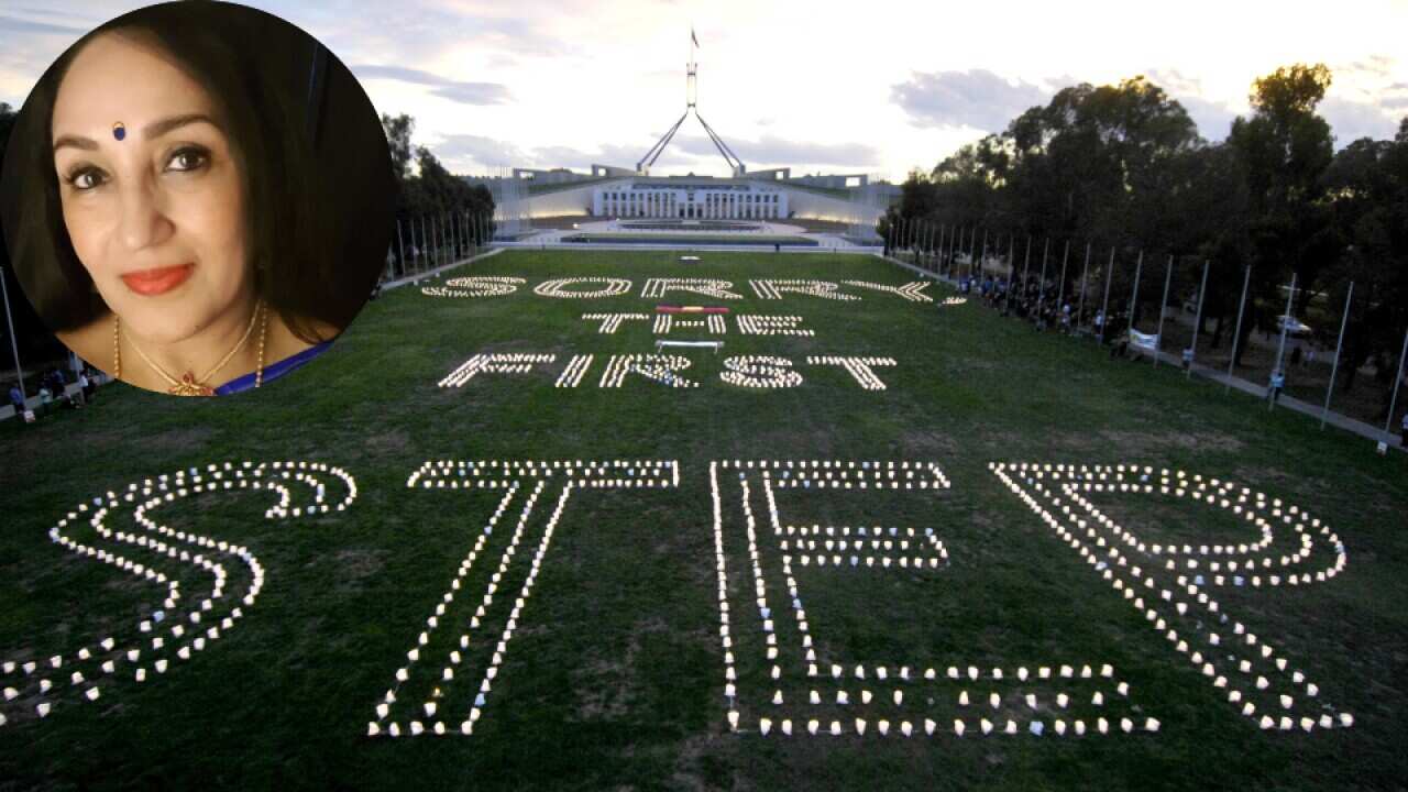 Candles are lit outside Parliament House Canberra