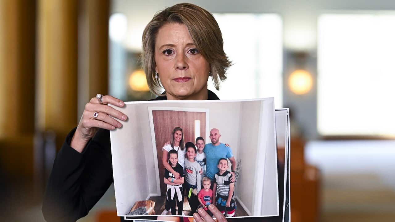 Labor's immigration spokeswoman Kristina Keneally with pictures of stranded Australian citizens