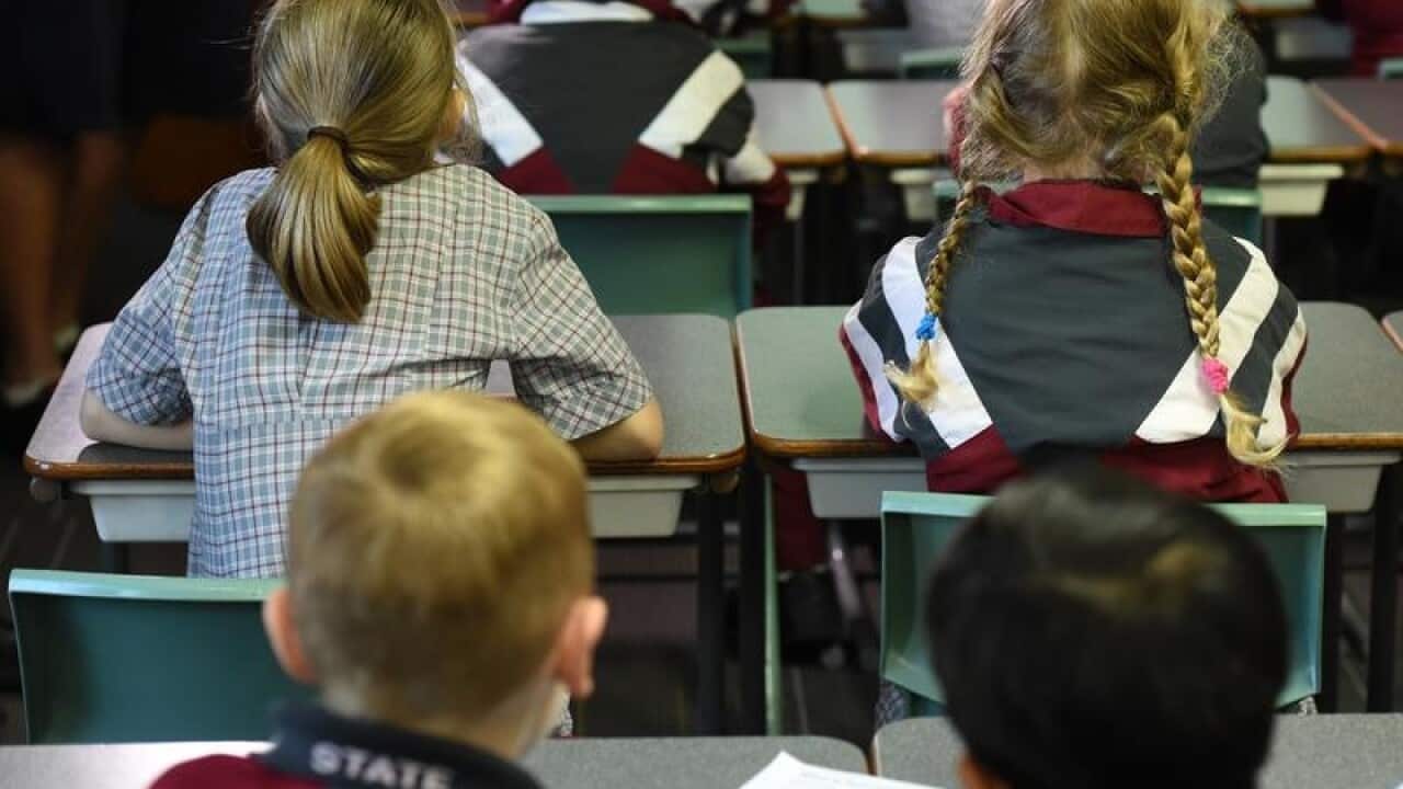 Children sit in a classroom
