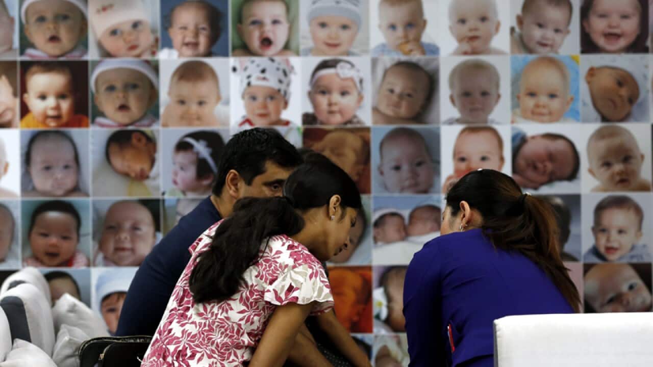 A foreign family talks to an advisor at a fertility clinic in Bangkok