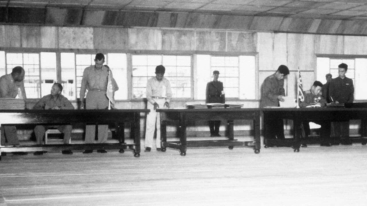 Delegates sign the Korean Armistice Agreement in P'anmunjŏm.