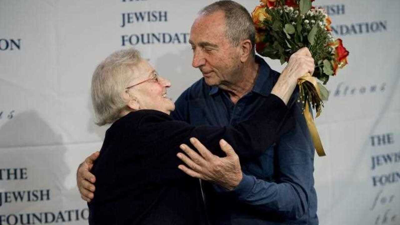 Krystyna Jakubowska (L), of Poland, hugs Michael Hochberg, of Israel, as the two are reunited during an event sponsored by the Jewish Foundation at John F. Kennedy airport in New York.