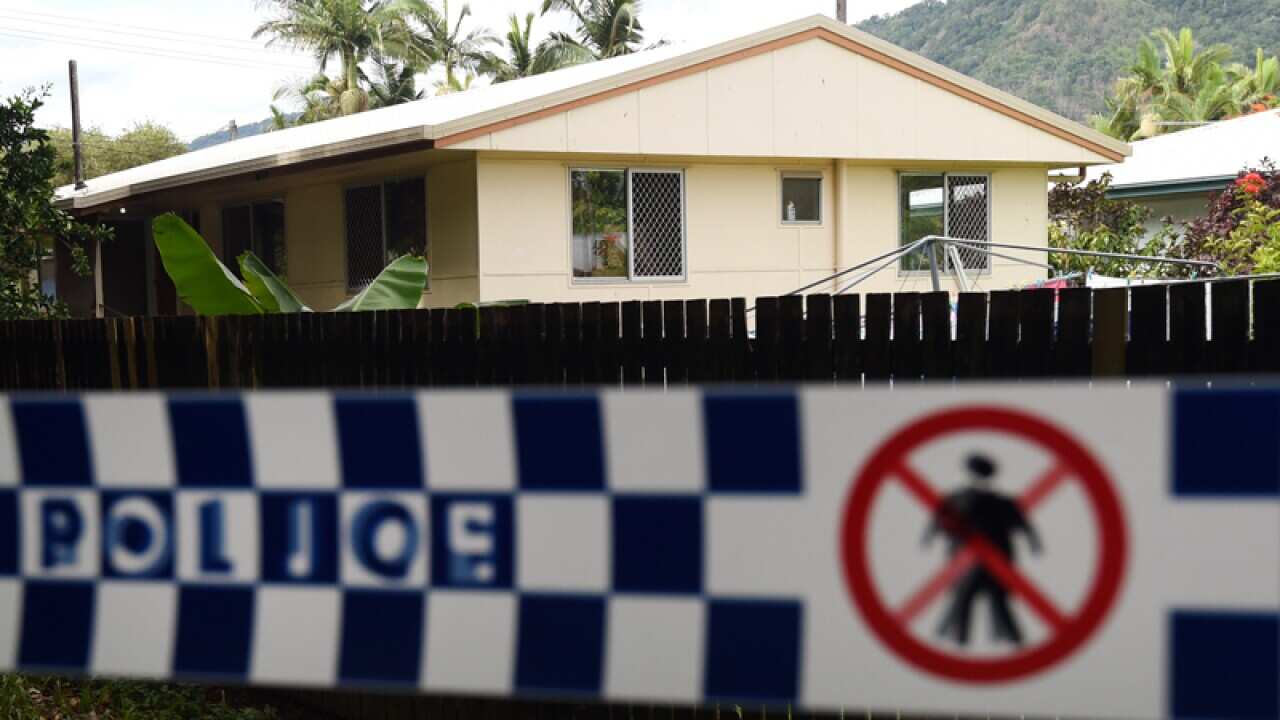Police tape is seen around a house in the Cairns suburb of Manoora