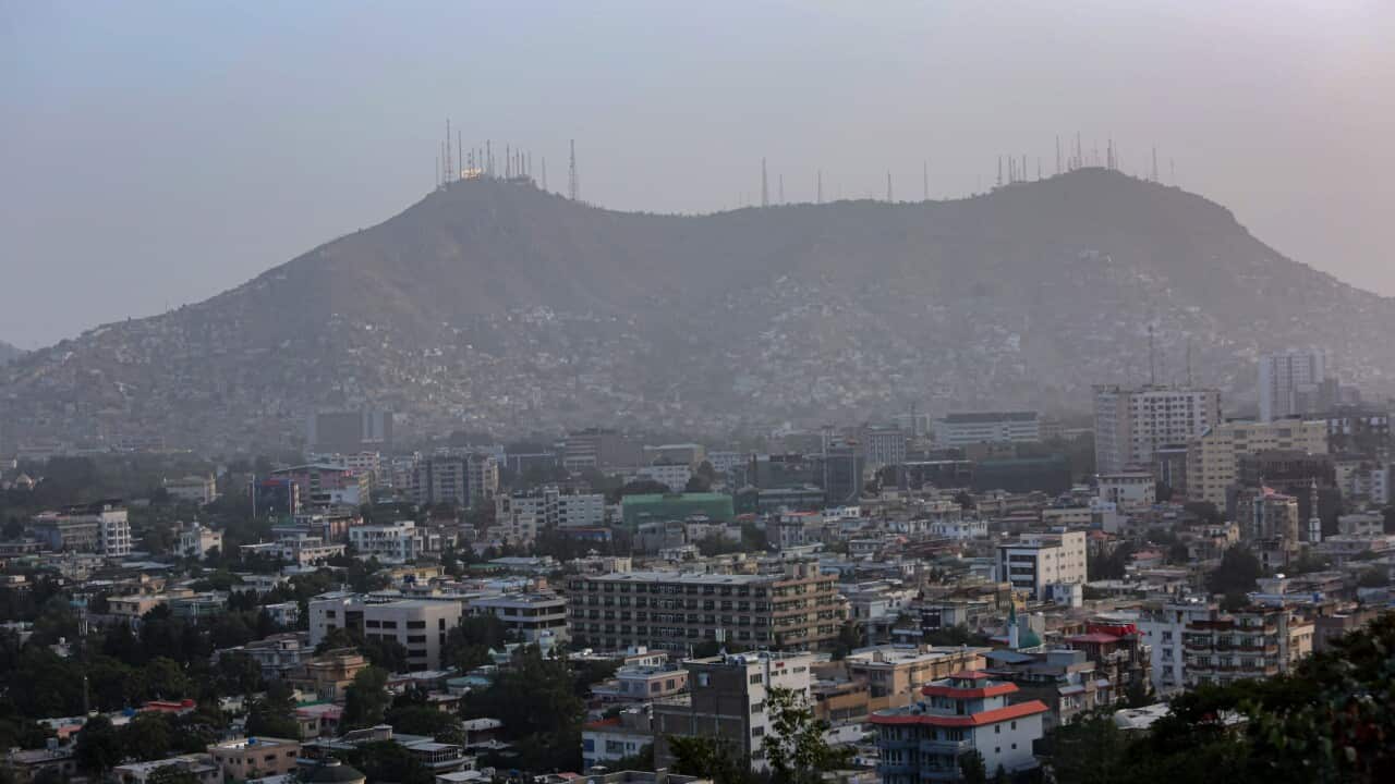 The Balkh province of Afghanistan with mountains and telecommunications towers in the backdrop.