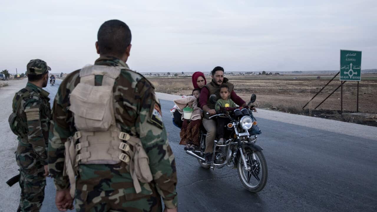 Syrian government troops man a checkpoint in the town of Tal Tamr in northwest Syria, Monday, Oct. 14, 2019. 