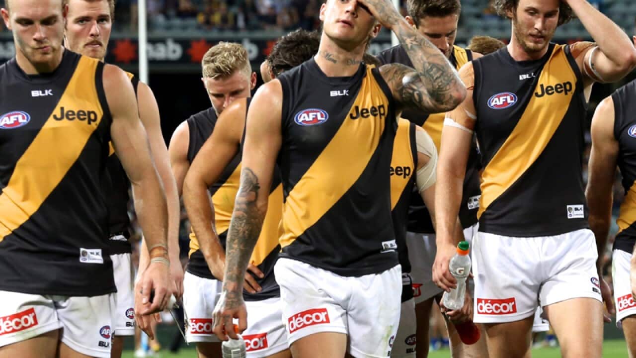 Richmond Tigers players leave the field after losing to