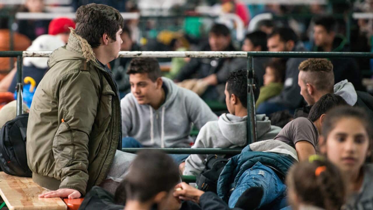 Refugees wait at a registration facility in Germany