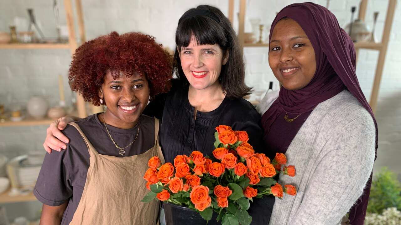 Betiel Tafsay (left) with Jane Marx and Asante Abubaker (right).