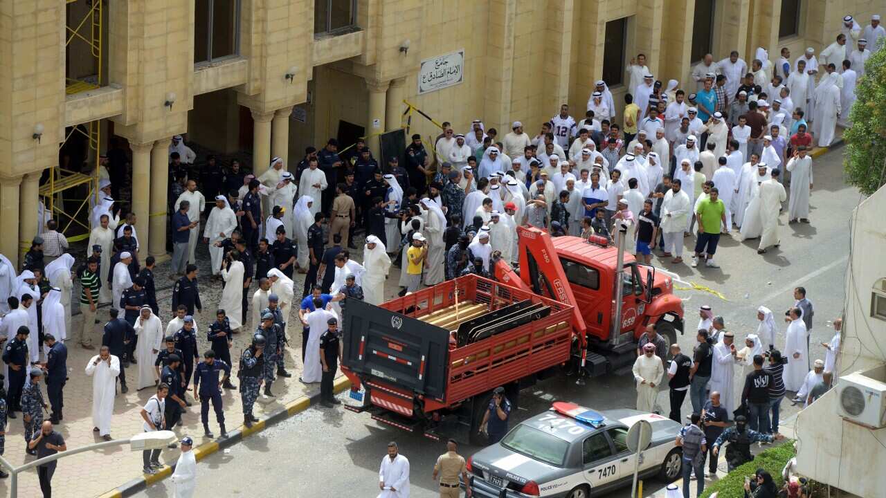 Security forces and worshippers gather outside Imam Sadiq Mosque following a blast in al-Sawaber, Kuwait City, Kuwait, 26 June 2015. (EPA/RAED QUTENA)