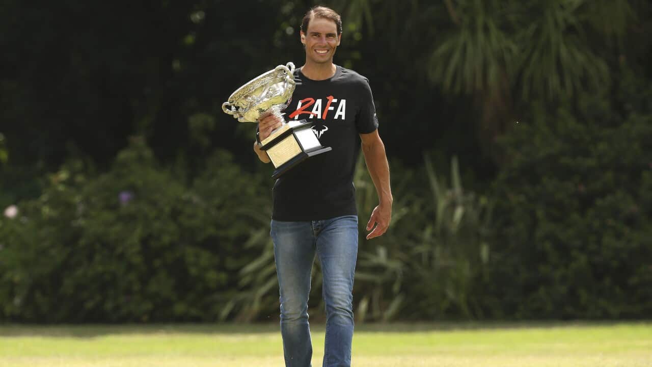 Men's singles champion Rafael Nadal poses for a photo with his trophy at Government House after the Australian Open in Melbourne.