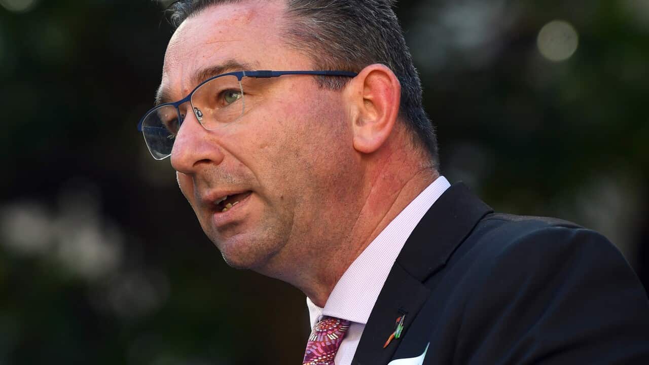 Man stands at a microphone.