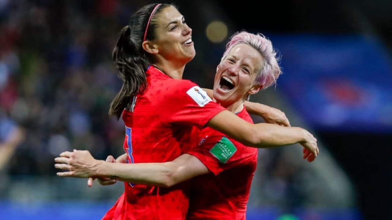 US striker Alex Morgan (left) is hugged by captain Megan Rapinoe (right) during their 13-0 win over Thailand