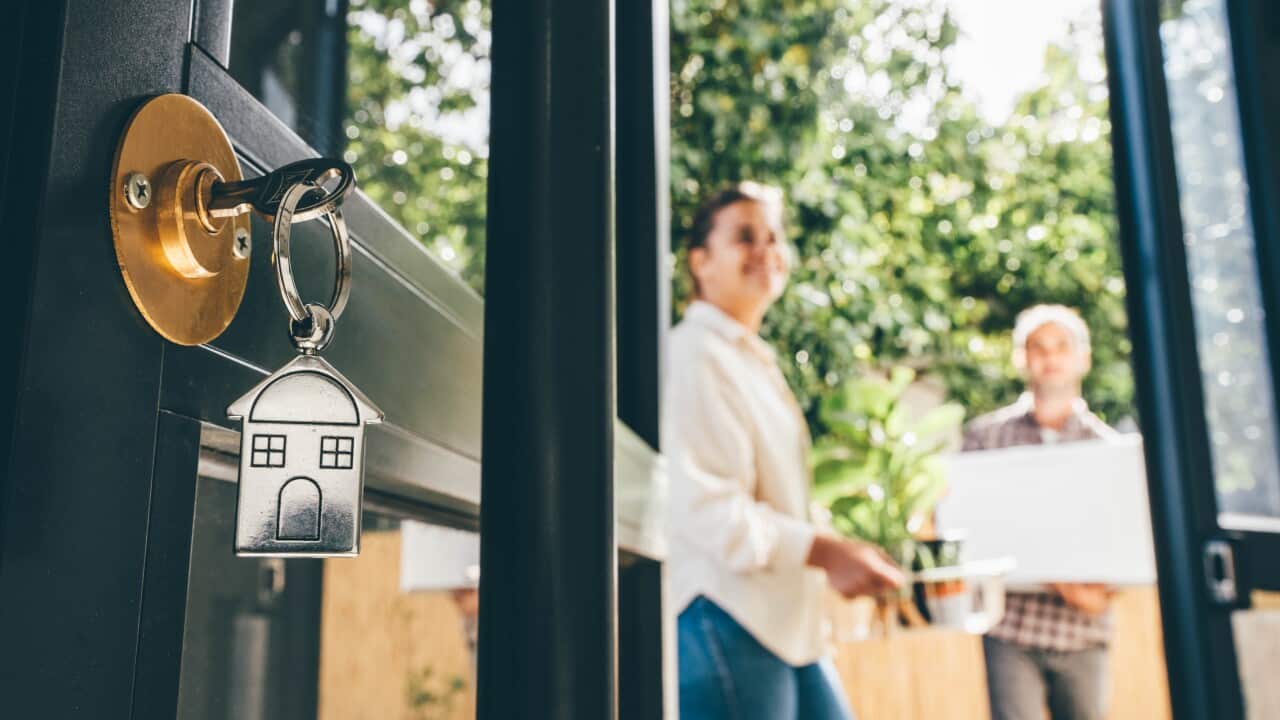 Couple celebrating moving day, mortgage, and relocation concept.