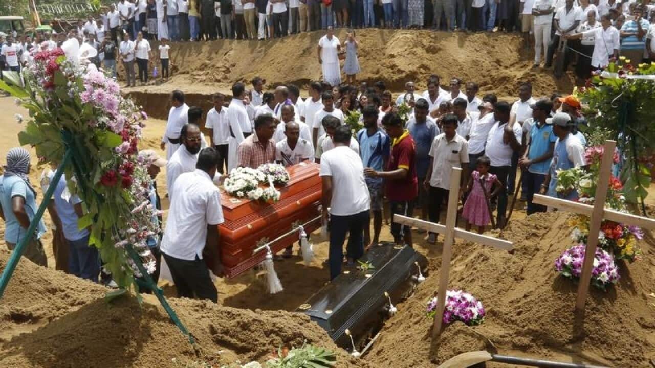 Relatives and friends bury victims of the bomb blasts in Colombo.