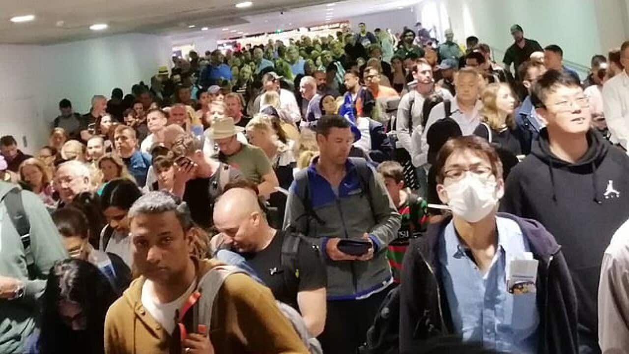Passengers queue at Melbourne Airport.
