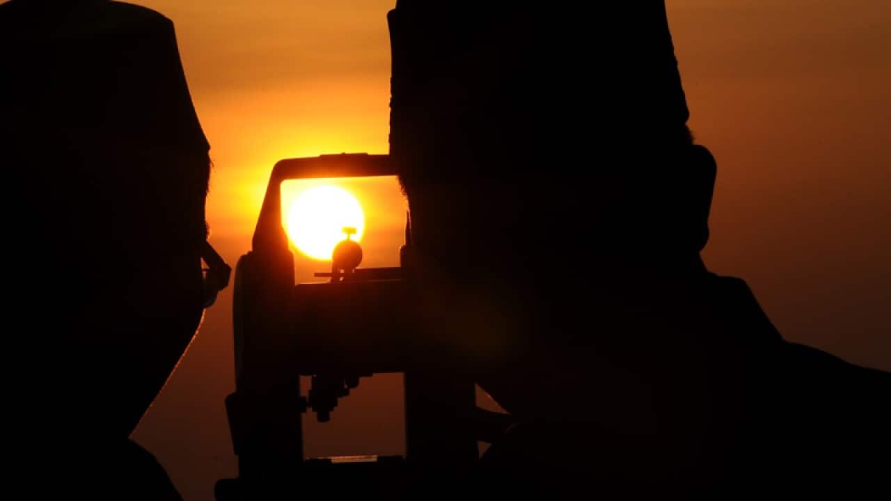 Indonesian Muslims hold a Rukyatul Hilal to see the new crescent moon that determines the end of Ramadan at Condro Dipo Hill in Gresik, Indonesia. (Robertus Pudyanto/Getty)