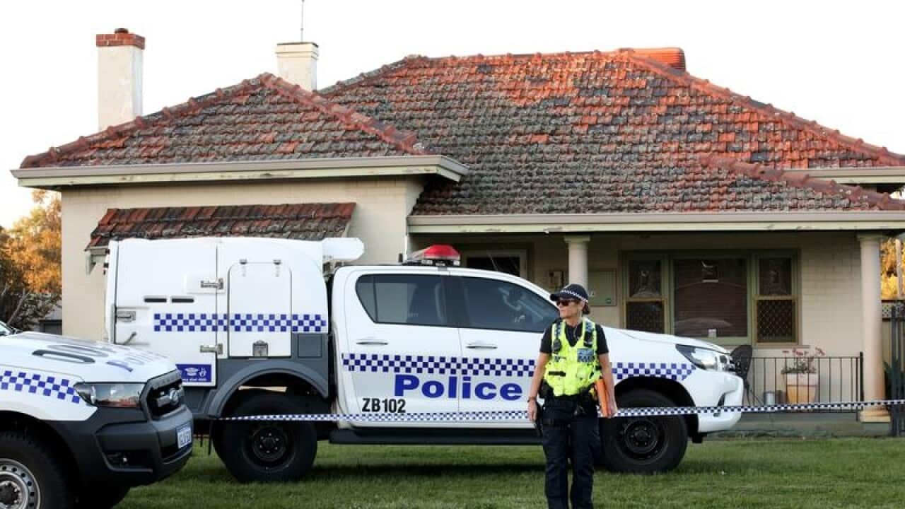Police outside the house where five bodies were found