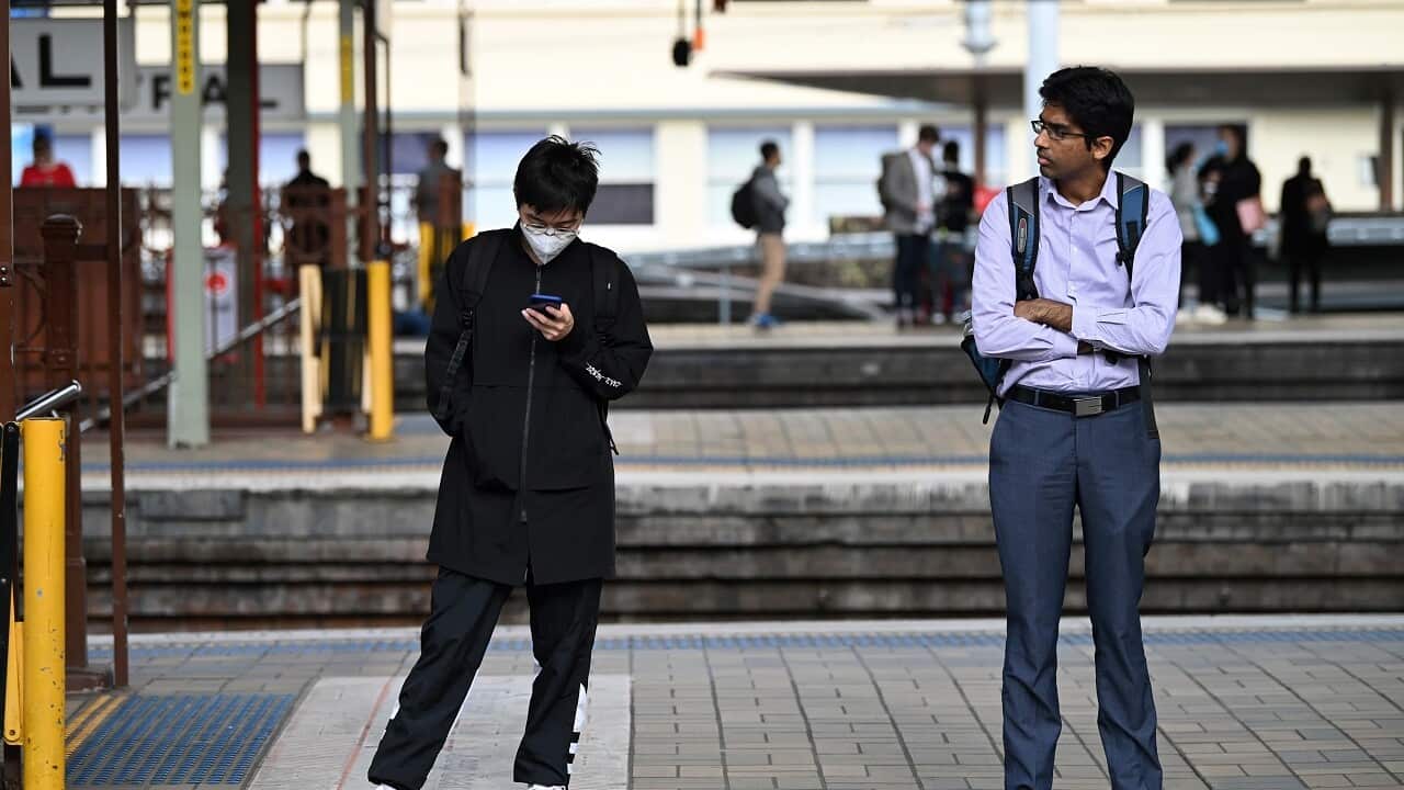 Rail passengers wait on a platform during peak hour at Central Station in Sydney, Tuesday, March 24, 2020, amid Covid-19 pandemic.