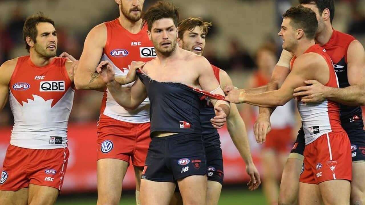 Tomas Bugg of the Demons (third from left)