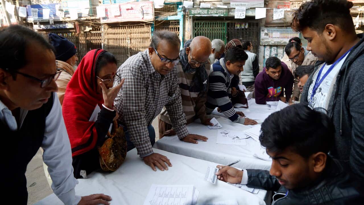 Bangladeshi voters register for with officials at a polling station for the 11th National Parliament Election in Dhaka, Bangladesh.