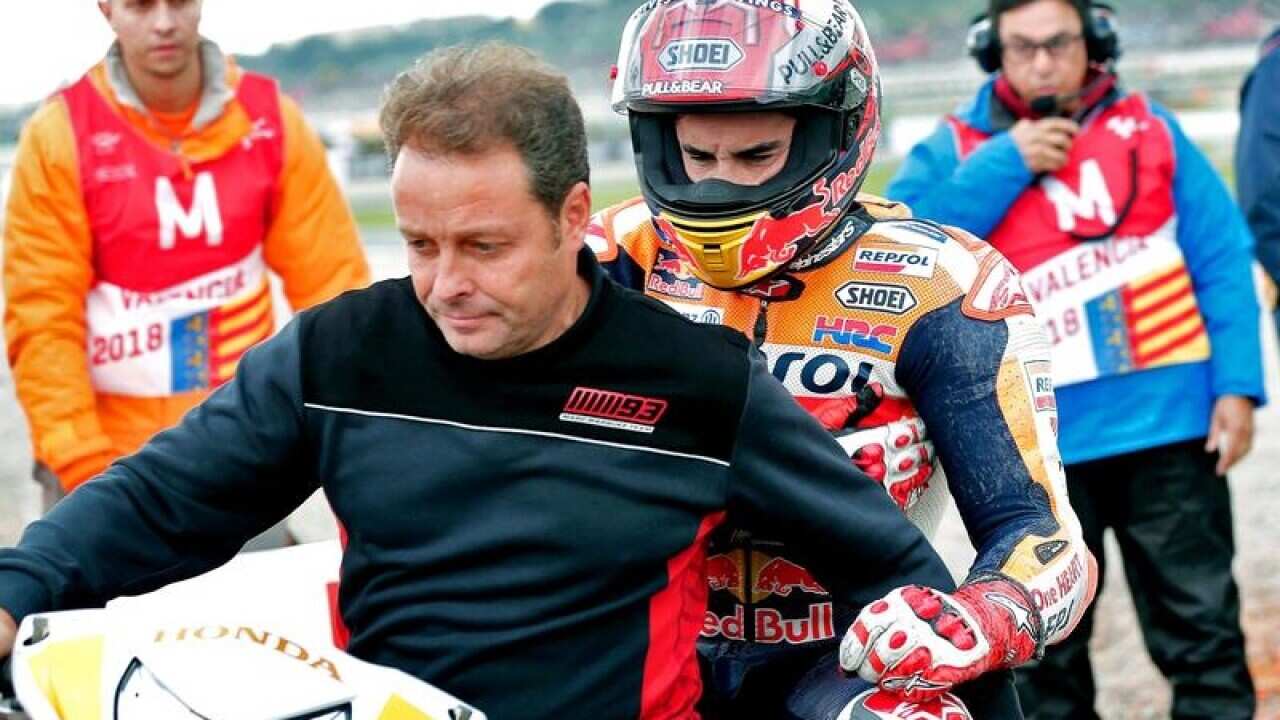 Marc Marquez leaves the track after the crash