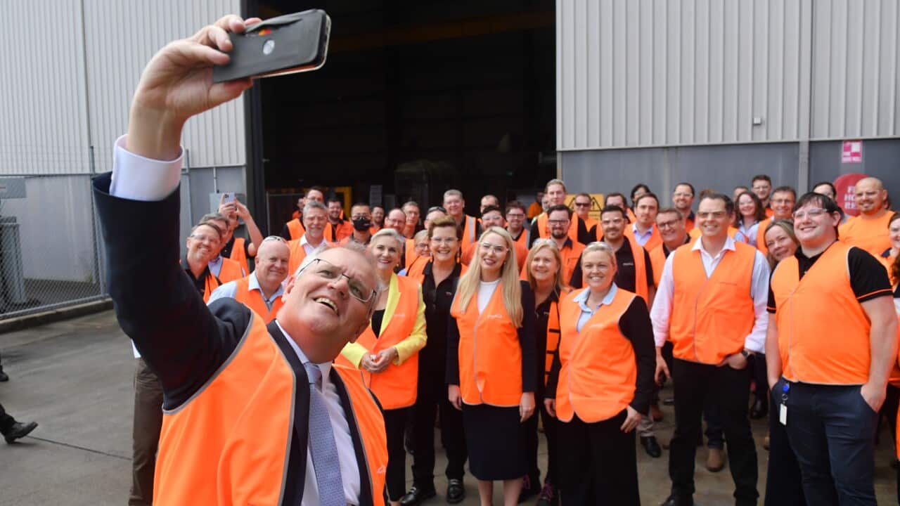 Prime Minister Scott Morrison takes a selfie with workers at an engineering facility specialising in renewable technology during a visit to the Hunter Valley, Monday, November 8, 2021. (AAP Image/Mick Tsikas) NO ARCHIVING