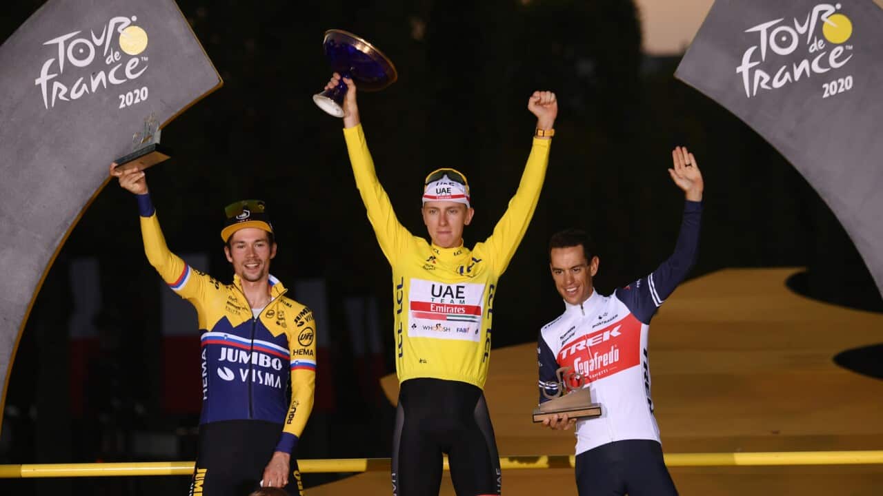 Richie Porte stands in third place on the podium next to Primoz Roglic and 2020 Tour de France winner Tadej Pogacar