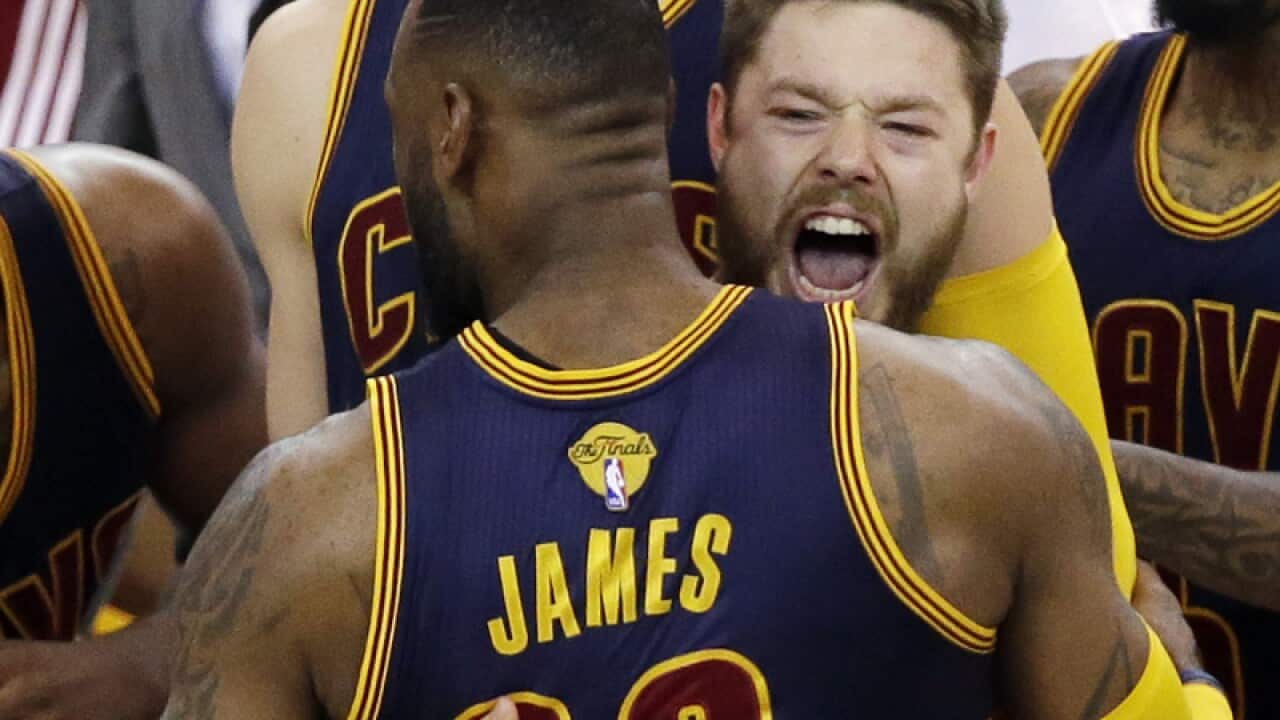 Cavaliers guard Matthew Dellavedova, right, hugs forward LeBron James