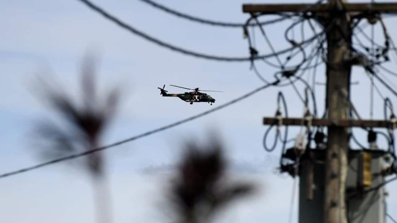 An army helicopter flies over Proserpine