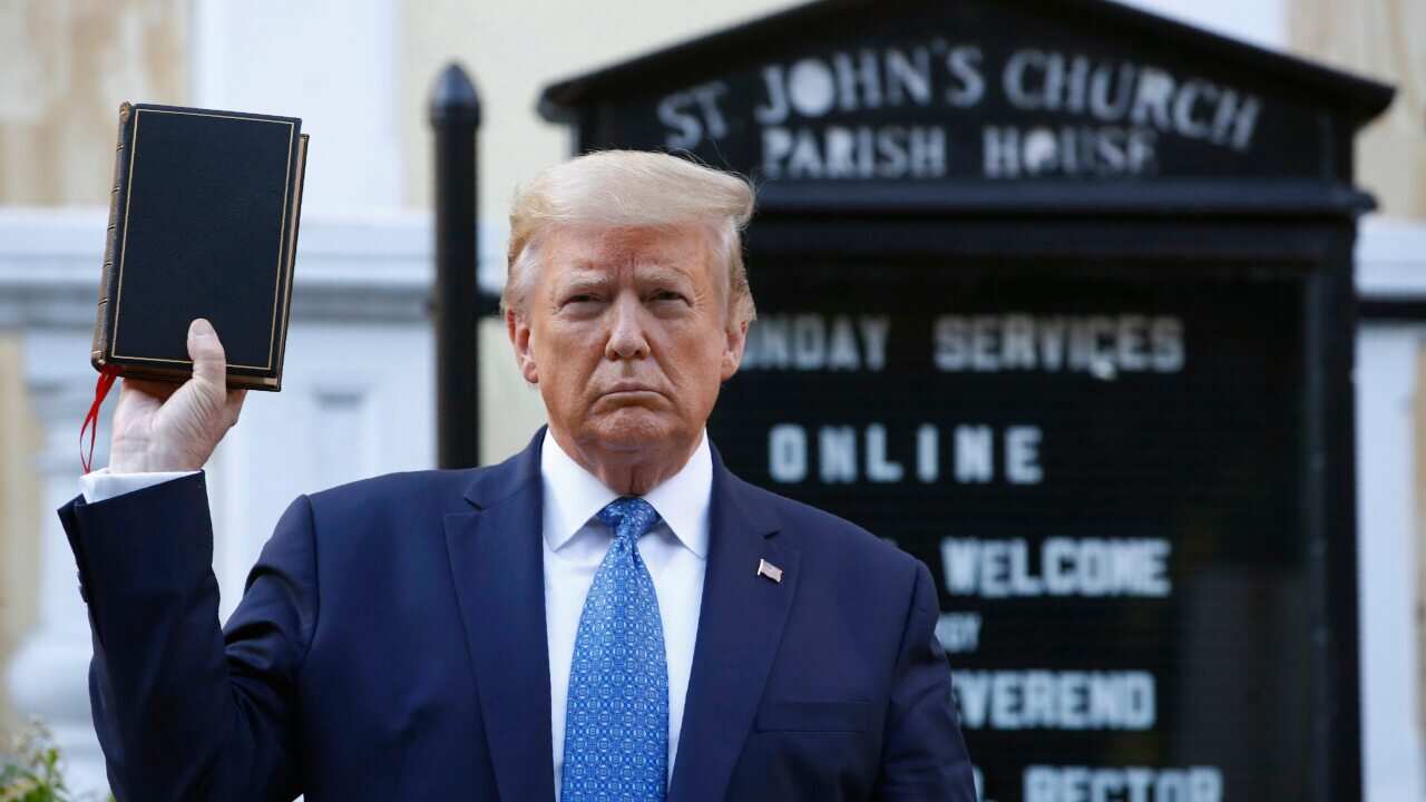 President Donald Trump holds a Bible as he visits outside St. John's Church across Lafayette Park from the White House on June 1.