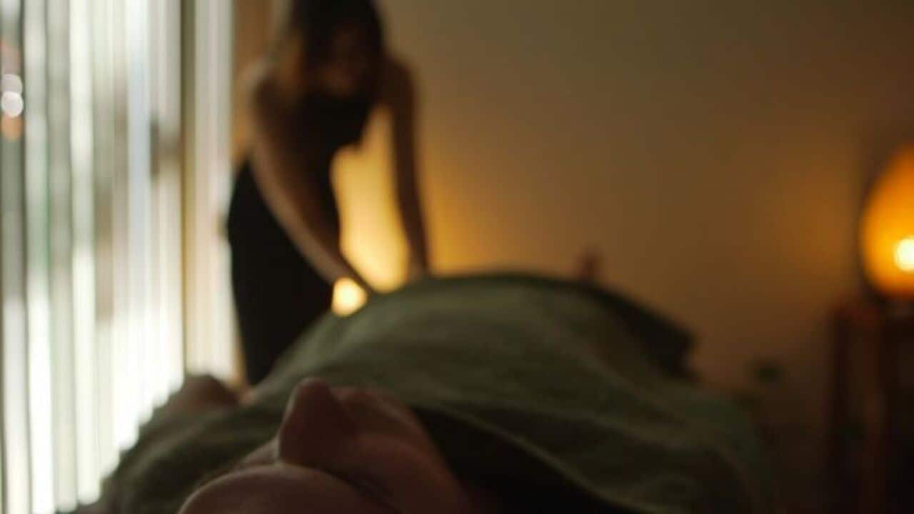 A masseuse working on a client