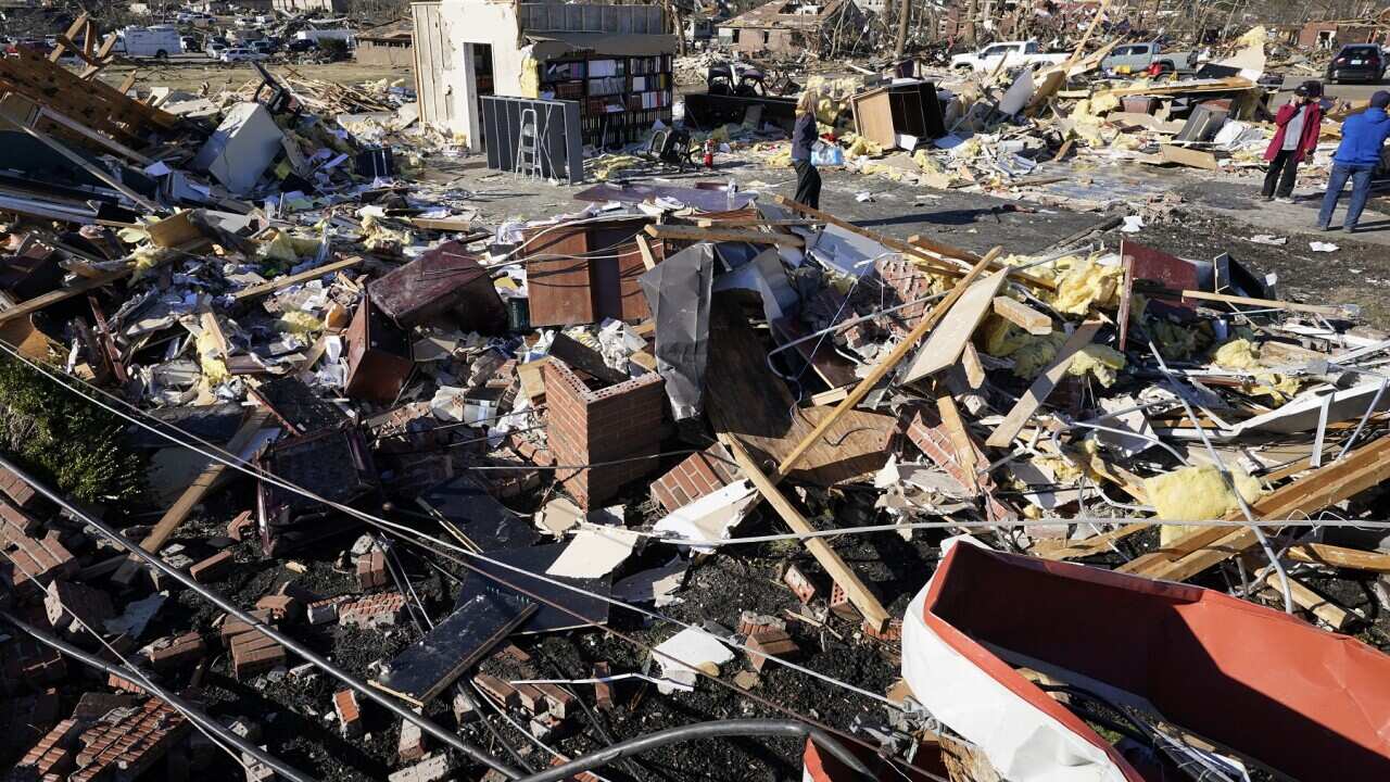People retrieve items from a destroyed law office in Mayfield, Kentucky