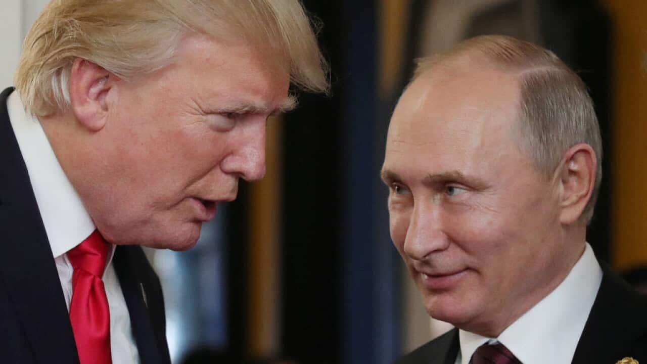 US President Donald Trump chats with Russia's President Vladimir Putin as they attend the APEC Economic Leaders' Meeting in 2017.