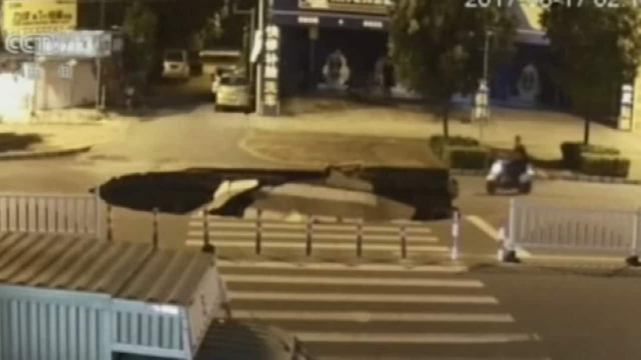 Scooter rider crashes into sinkhole while on mobile phone