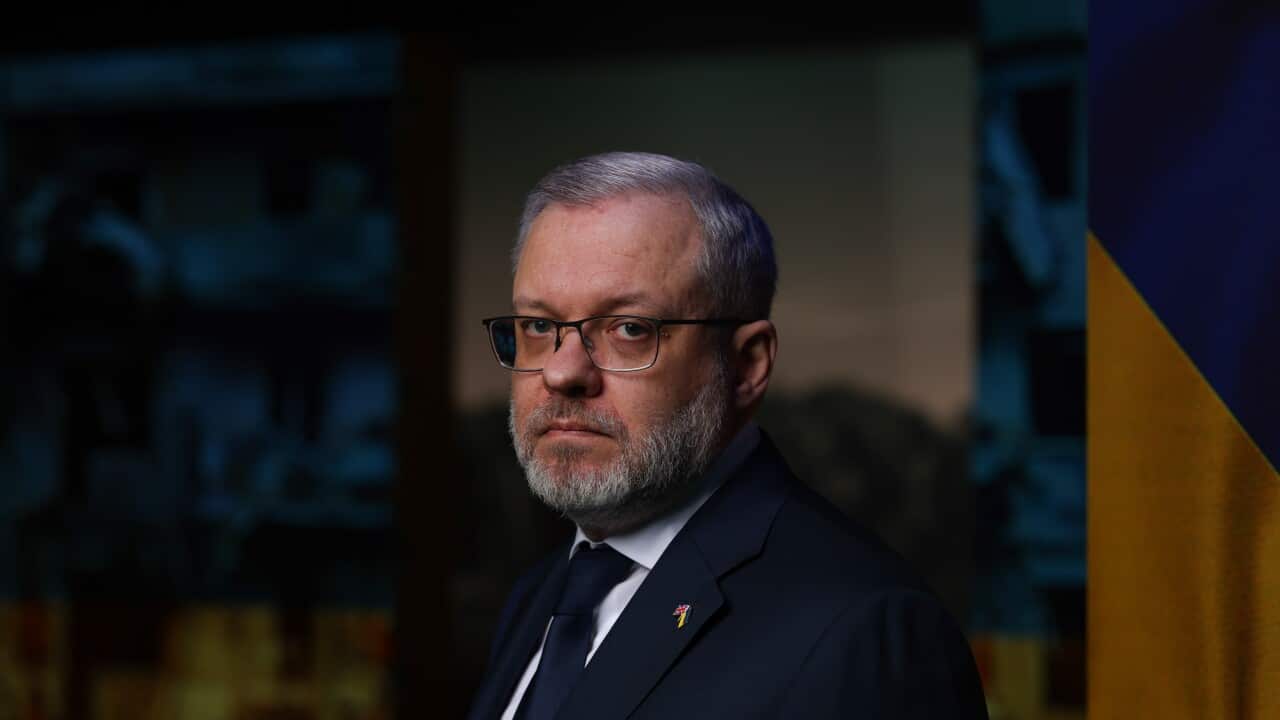 German Galushchenko in a suit staring with a serious expression at the camera