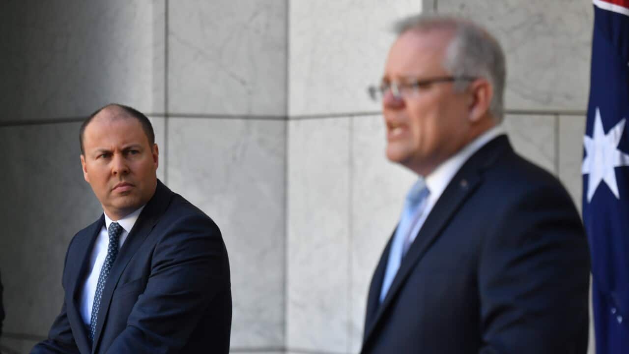 Treasurer Josh Frydenberg and Prime Minister Scott Morrison at a press conference to announce the government's coronavirus stimulus package at Parliament House in Canberra, Sunday, March 22, 2020.