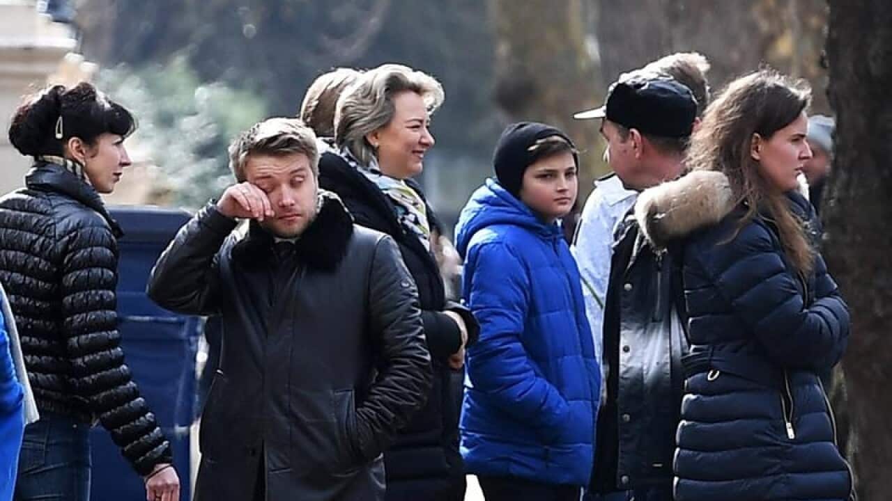 Russian diplomats and their family members leave the embassy in London