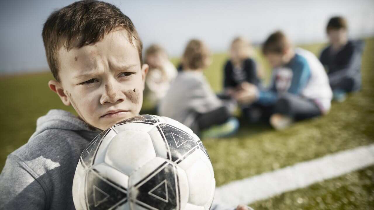 Boy with dirty face on soccer field