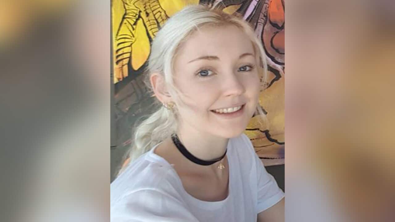 A young blonde woman with her hair tied back