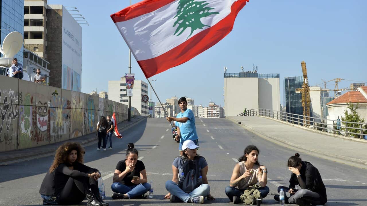 Protesters block the main highway during ongoing anti-government protests in Beirut.