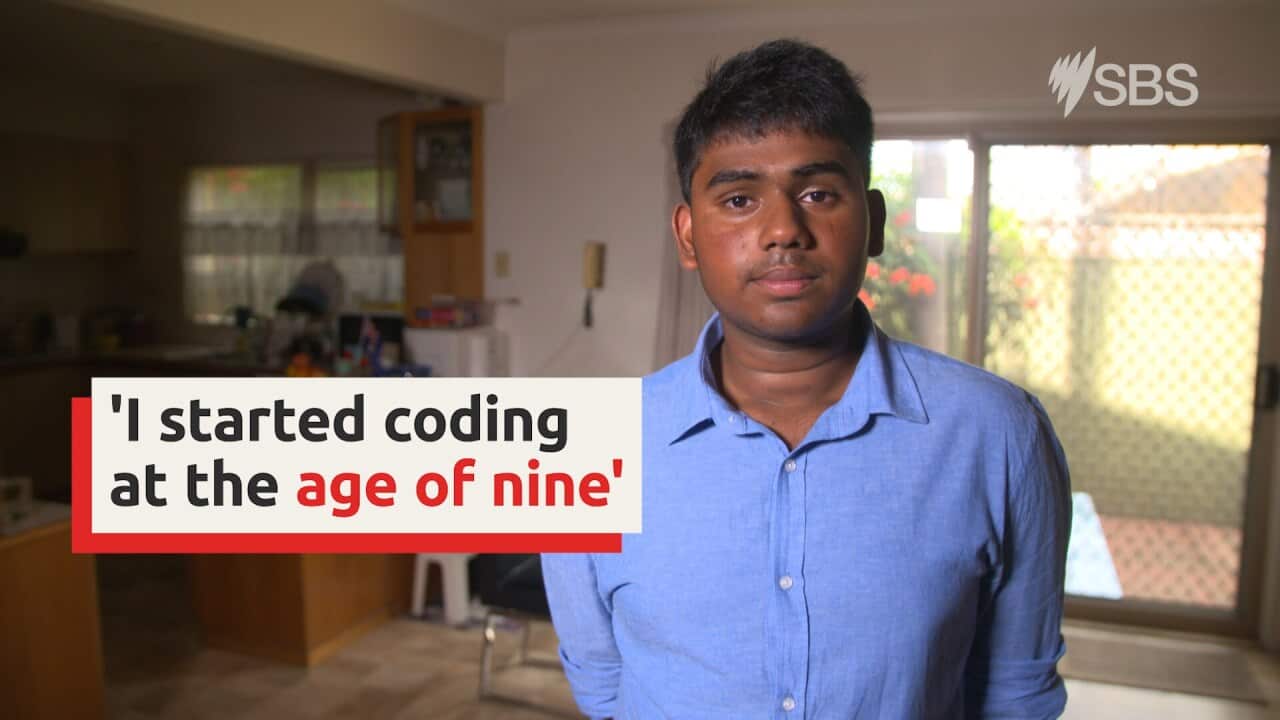 Teenage boy stands in room