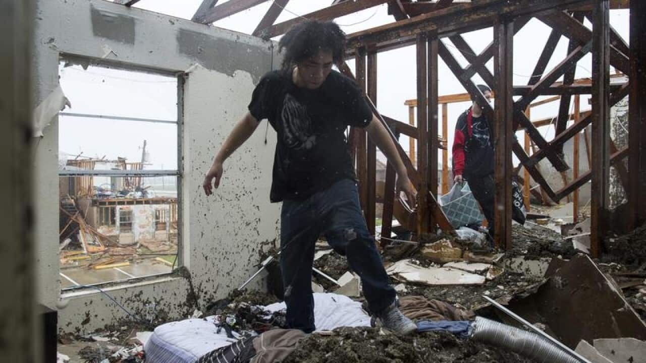 Michael Thomas and his brother Deeantre try to collect belongings