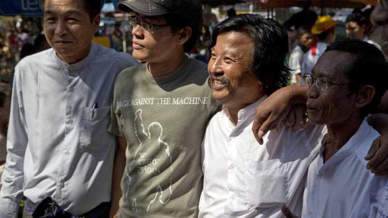 Soe Soe, second right, an activist who demands the rule of law and a political prisoner just released from Insein Prison, poses for a picture outside the prison in Yangon, Myanmar, Friday, Jan. 22, 2016. 